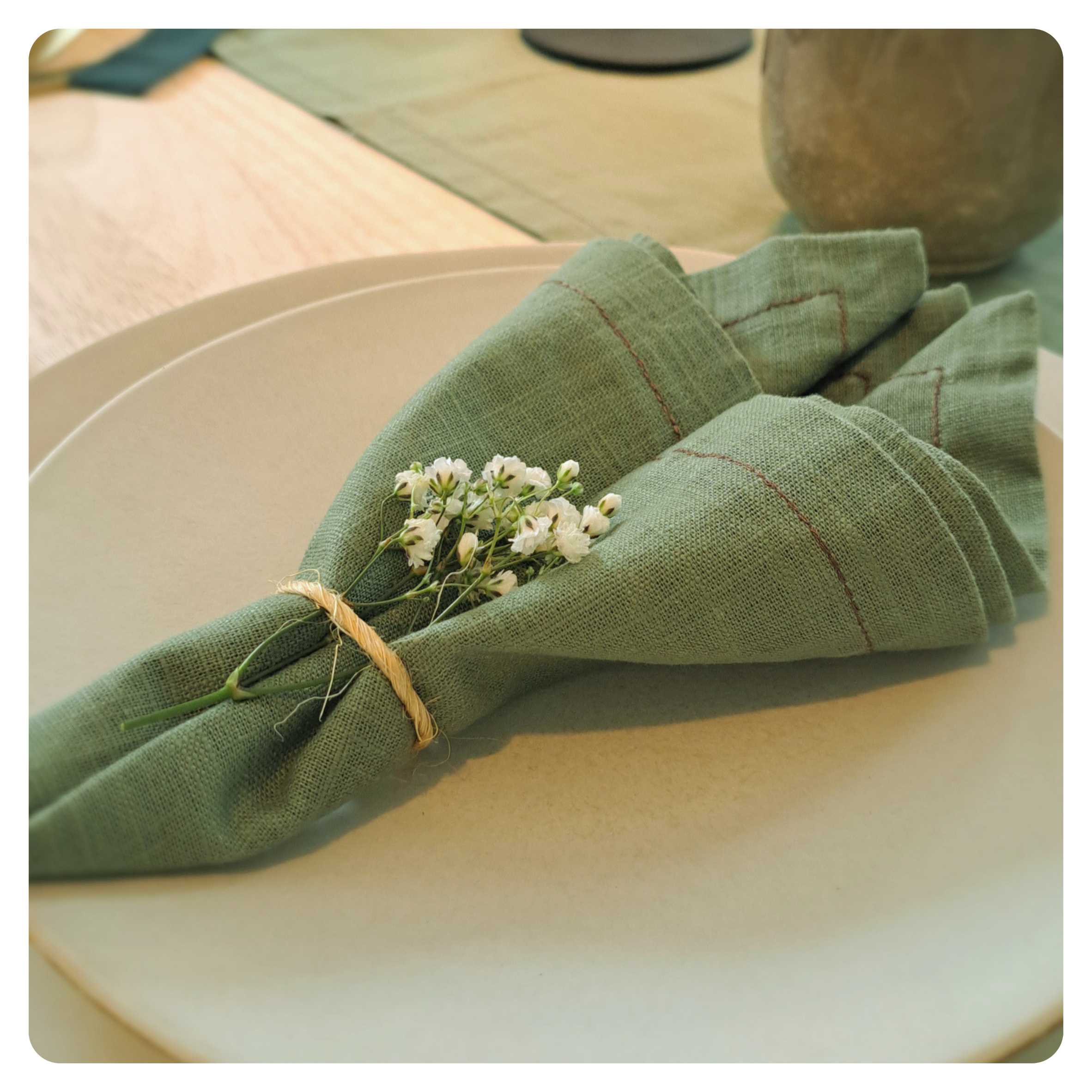 Sage green napkin on place setting
